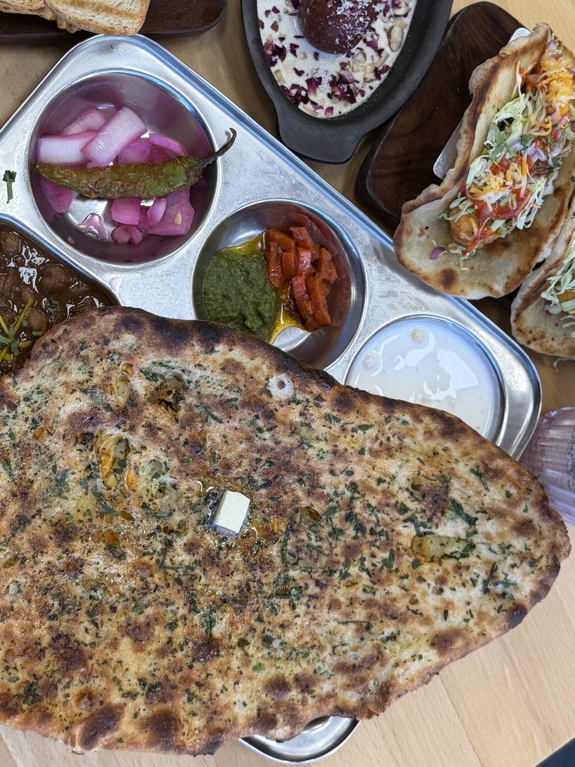 A fresh Akash Chaat House spread — Amritsari kulcha, thali, gulab jamun and more